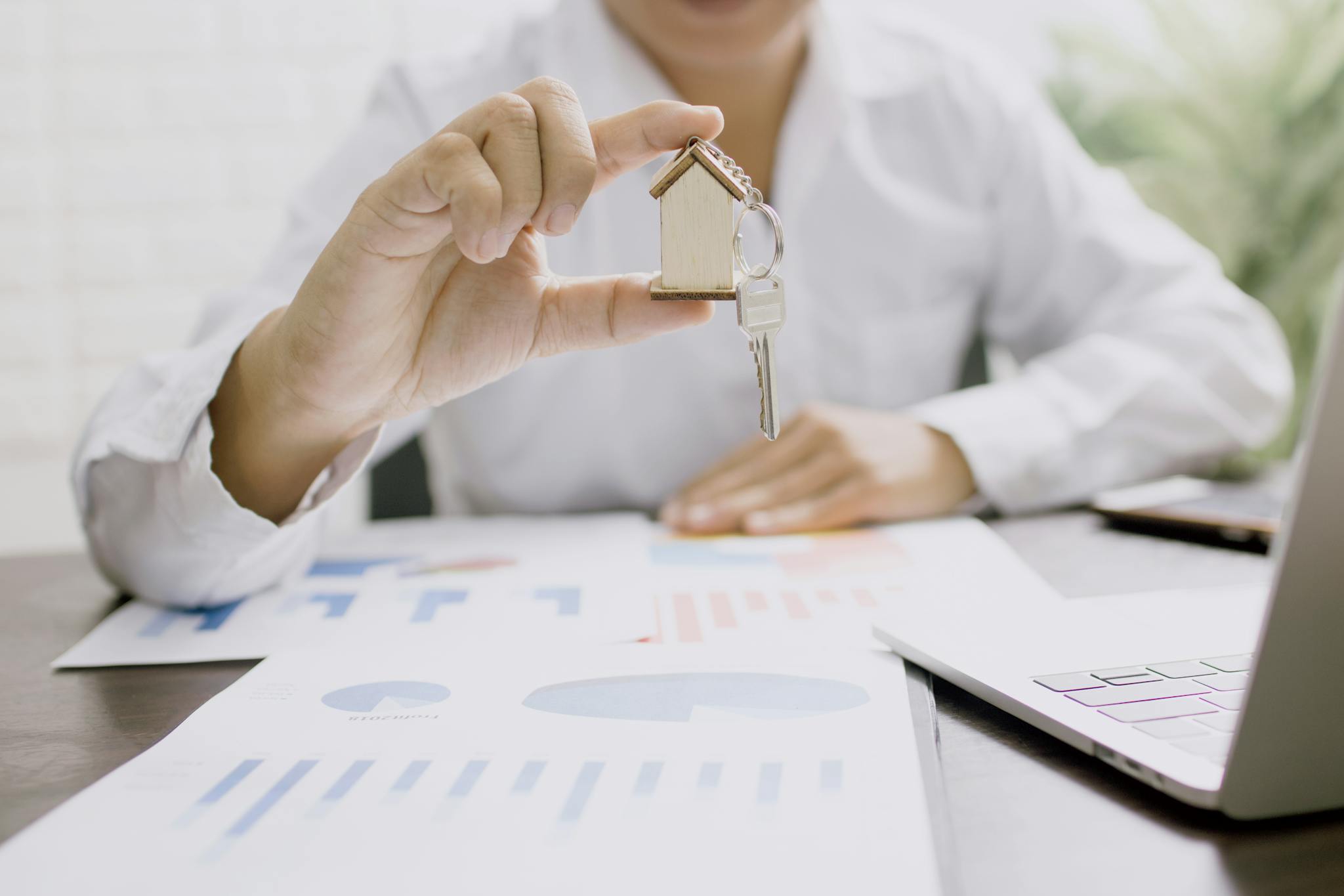 real estate professional presenting a house model